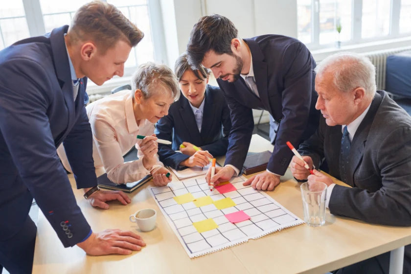 Business professionals collaborating on a board game, discussing strategies and ideas in a creative workspace.